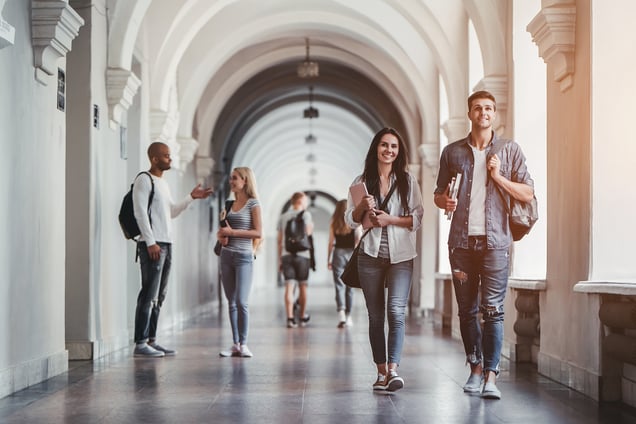 Why College is Worth the Cost - college students walking in a corridor