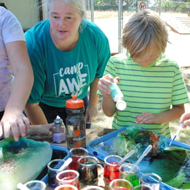 Kim Boyd facilitating art workshop with local child