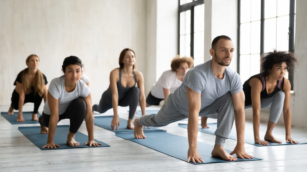 Yoga instructor using scheduling software on tablet